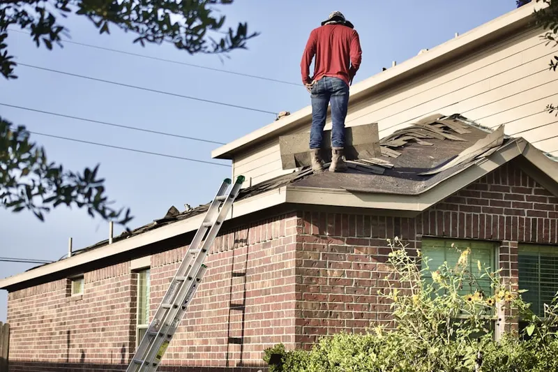 Professional roofer working on a residential roof in Frankenmuth